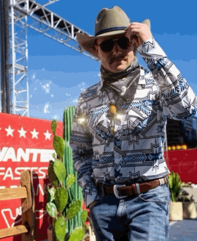 a man wearing a cowboy hat and sunglasses stands in front of a sign that says wanted