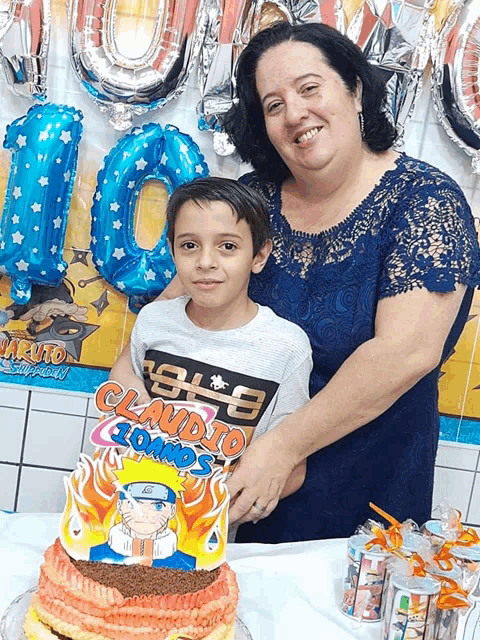 a woman holds a young boy in front of a cake that says claudio