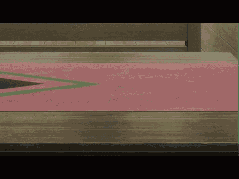 a pink rug with a green and black triangle on it