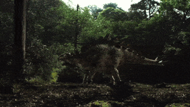 a dinosaur is standing in the middle of a dark forest