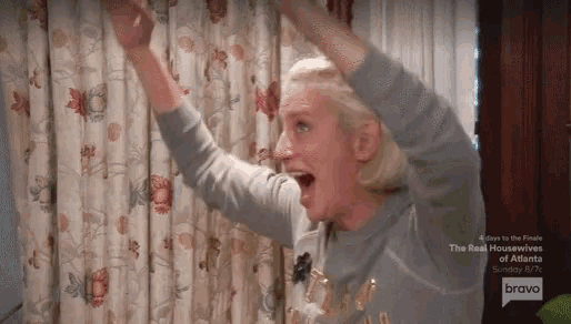 a woman with her arms in the air is on bravo