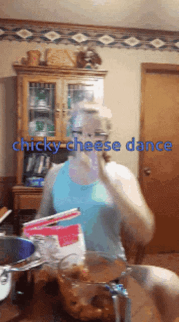 a woman in a kitchen with the words " chicky cheese dance "