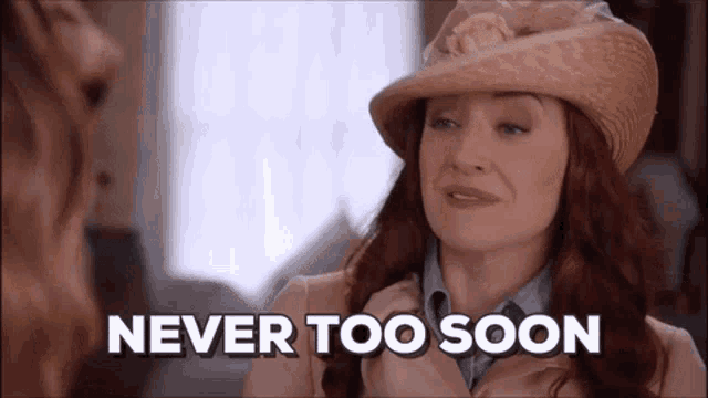 a woman wearing a hat and trench coat says never too soon