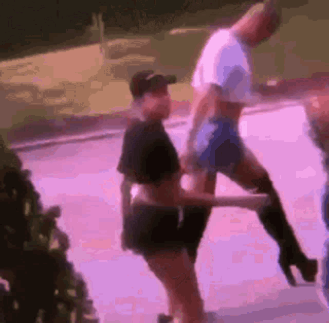 a group of people are standing next to each other on a street .