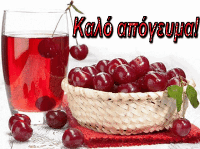 a basket of cherries sits next to a glass of cherry juice and a glass of cherry juice