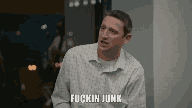 a man wearing a plaid shirt says fuckin junk