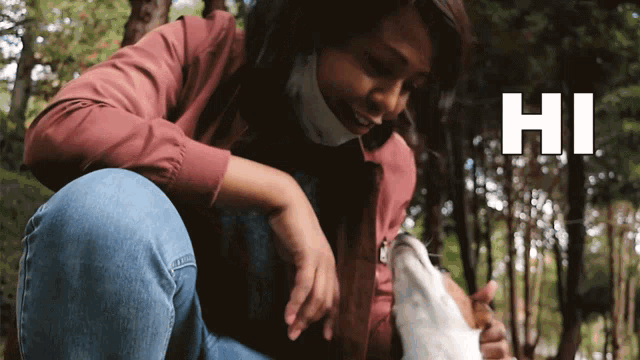 a woman wearing a face mask is kneeling down next to a dog and the word hi is on the bottom right