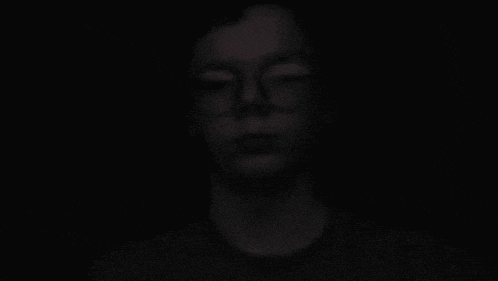 a close up of a person screaming in the dark