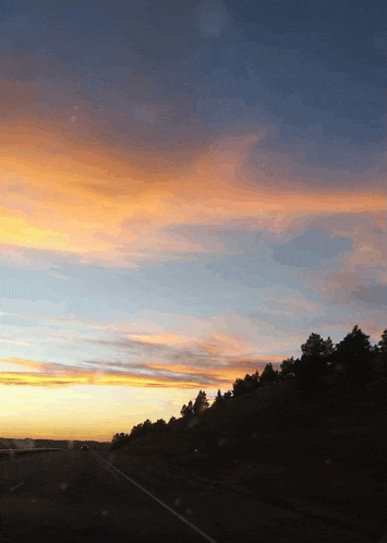 a highway with a sunset in the background