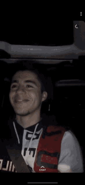 a young man wearing a vest with the number 17 on it is smiling