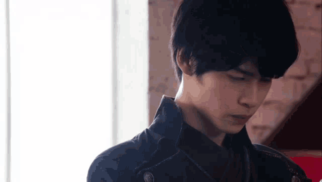 a close up of a young man 's face in a room .