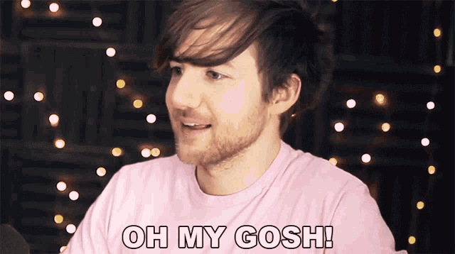 a man wearing a pink shirt with the words oh my gosh on it