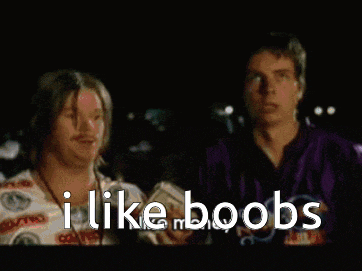 a man in a colorful shirt is sitting in a chair and says i like boobs
