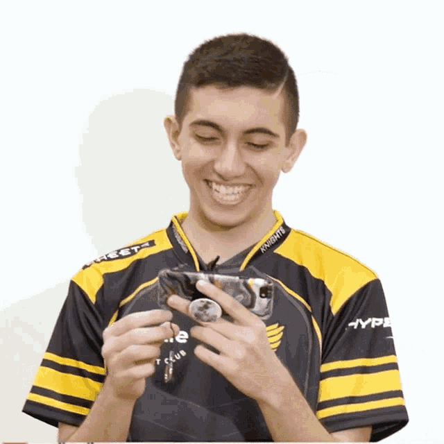 a man wearing a black and yellow shirt that says knights on the sleeves