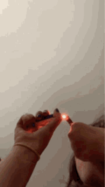 a person is lighting a lighter with a lighter .