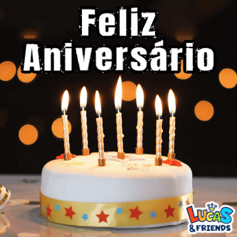 a birthday cake with lit candles and the words feliz aniversario