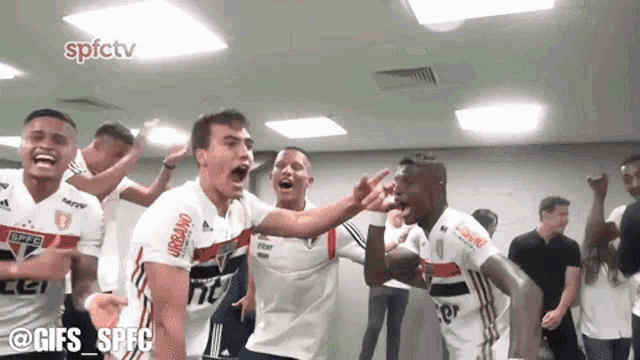 a group of soccer players are celebrating in a room with the words spfctv in the corner