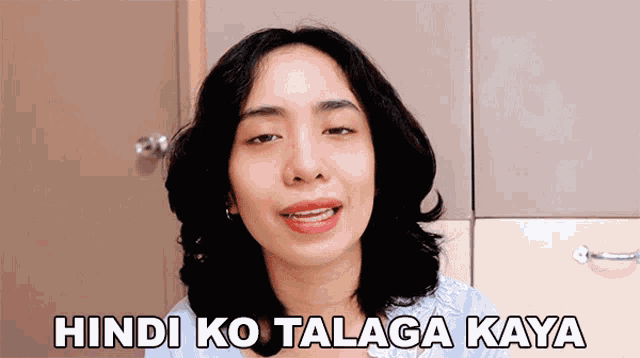 a woman says hindi ko talaga kaya in front of a brown cabinet
