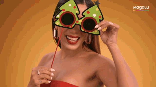 a woman wearing a pair of christmas tree glasses