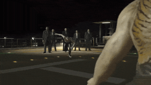 a man is doing a trick in front of a group of people