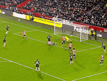 a soccer game is being played on a field that has an ad for pension bank