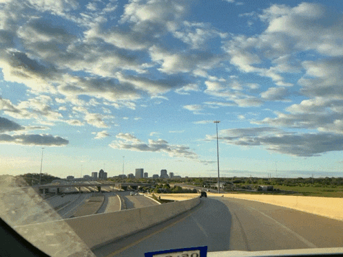 a view of a city from a highway with a sticker on the windshield that says $ 1.30