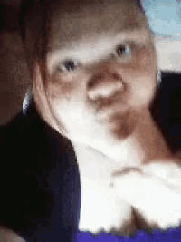 a close up of a woman 's face with a blue background