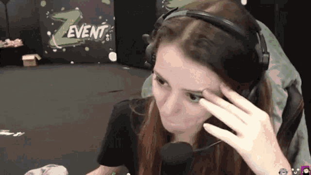 a woman wearing headphones and a microphone in front of a z event pillow