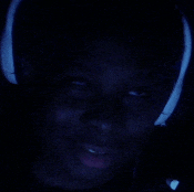 a close up of a person wearing headphones and smiling