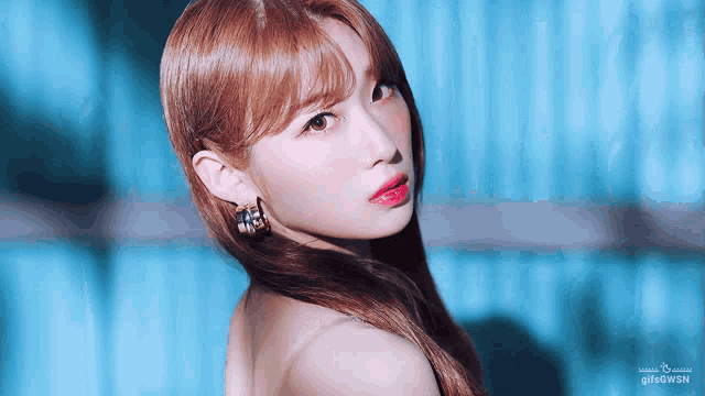 a close up of a woman 's face with a blue background and the word gif on the bottom right