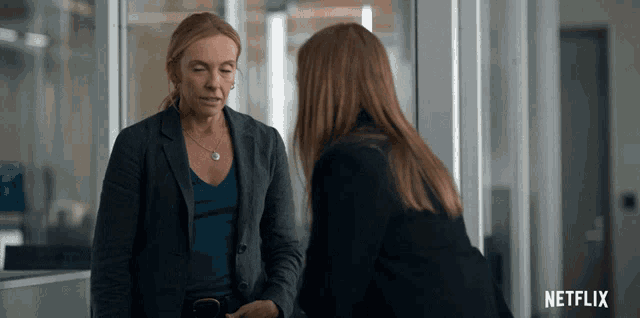 two women standing next to each other with netflix written on the bottom right