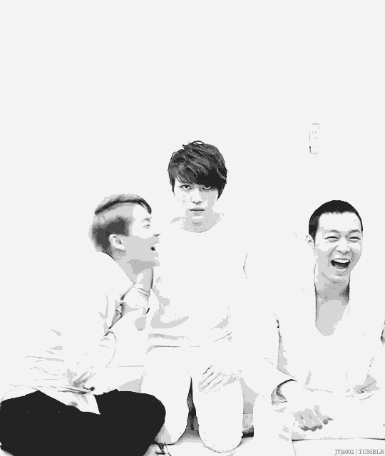 a group of young men are laughing together in a black and white photo with the name jynx on the bottom