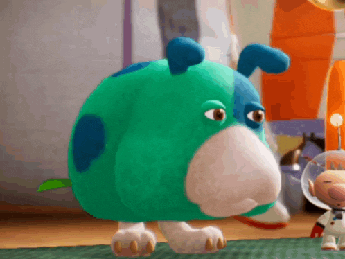 a stuffed animal that looks like a dog with a blue spot on its nose