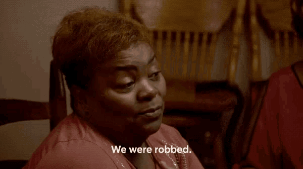 a woman says we were robbed while holding her hand up
