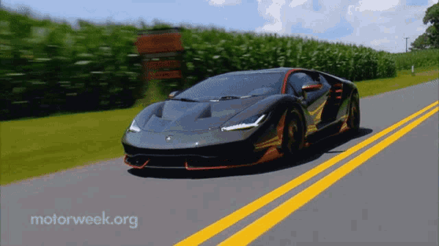a sports car is driving down a road with motorweek.org written on the bottom