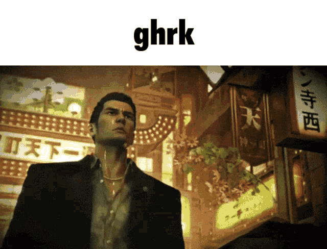 a man in a suit is standing in front of a sign that says ghrk