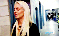 a woman with blonde hair is standing in a hallway that says total divas on it