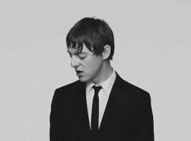 a black and white photo of a man in a suit