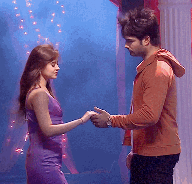 a man and a woman are holding hands in a room