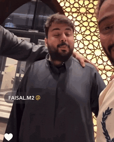 two men are posing for a picture with the name faisal.m2 at the top