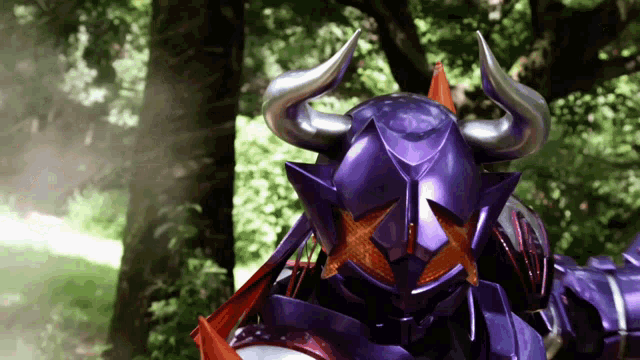 a purple monster with horns and a star on his face