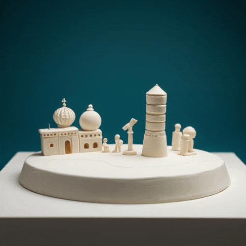 a model of a city with buildings and a telescope on a table