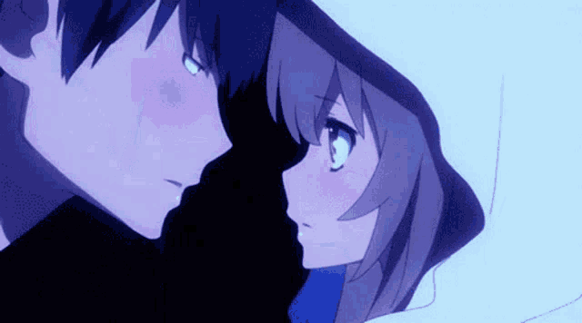 a boy and a girl are looking at each other in the dark