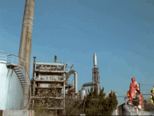 a red power ranger is riding on the back of a monster