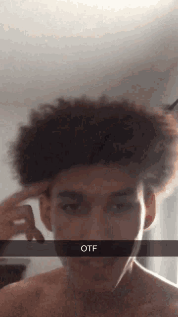 a man taking a selfie with a caption that says otf on it