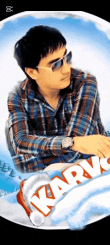 a man wearing sunglasses and a watch is sitting in front of a karv candy bar