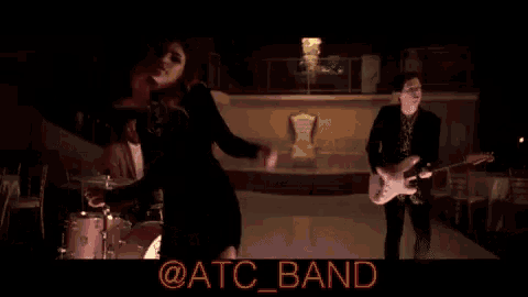 a band is playing in a dark room and the band is called @atc_band