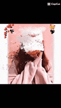 a girl wearing a white hat and a pink sweater has her face covered in hearts