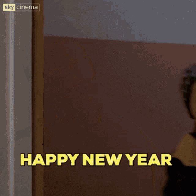 a young boy in a beanie says " happy new year "