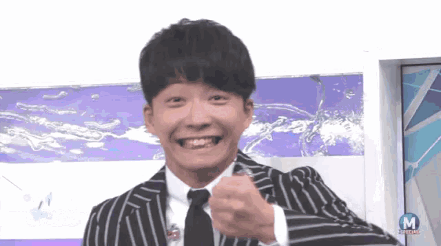 a man in a suit and tie is smiling in front of a sign that says special